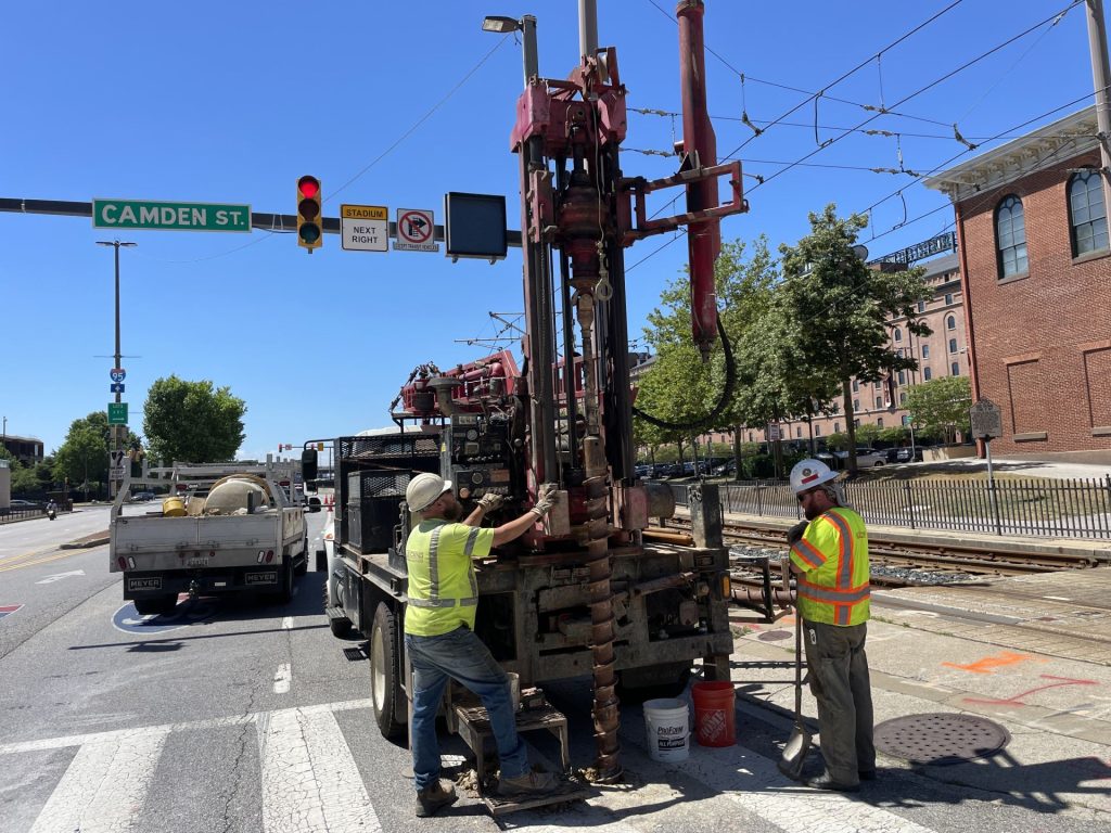Geotechnical drilling rig operating on city street to evaluate subsurface conditions for construction project